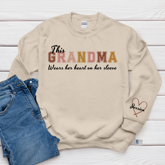 This Grandma Wears Her Heart On Her Sleeve - Family Personalized Custom Unisex Sweatshirt With Design On Sleeve - Gift For Mom, Grandma